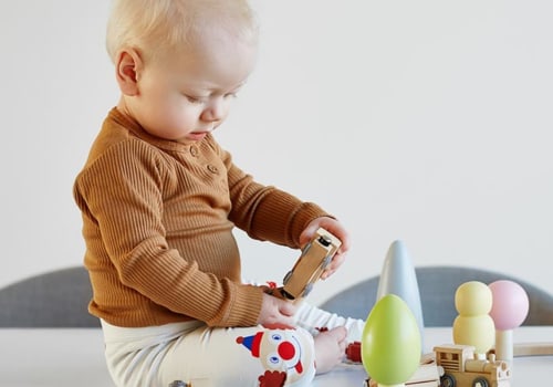 Why should babies play with wooden toys?